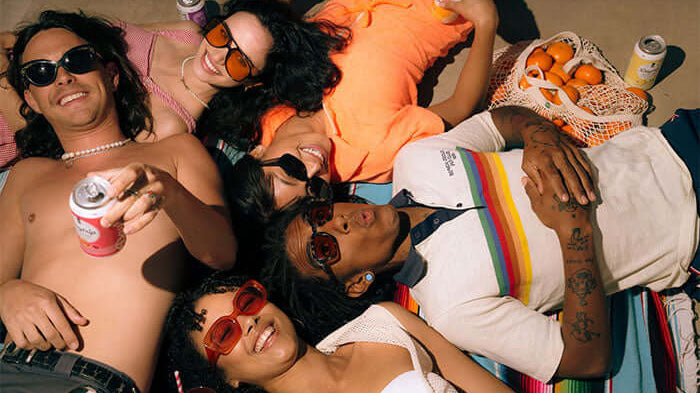 A group of stylish 20-something friends lying down and relaxing with Daytrip CBD infused sparkling water