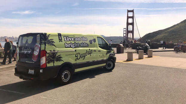 the daytrip team sprinter van parked in marin county with the golden gate bridge in the background