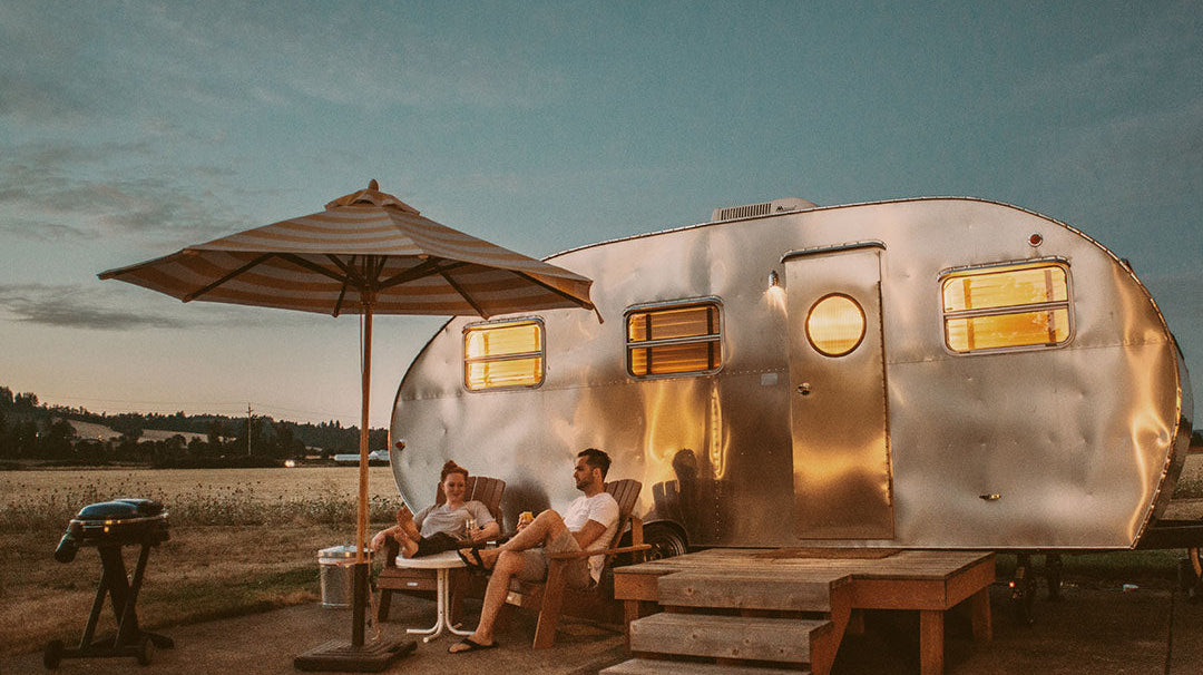 Twilight evening picture of vintage camper in the desert