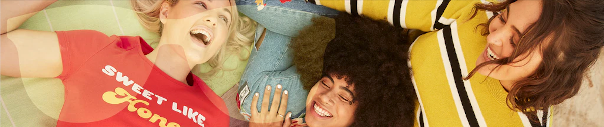 A group of women lying down and smiling.