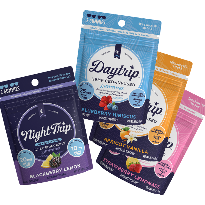 Sample pack showing a stack of 4-pack packaging renders of all four flavors of gummies: Night Trip CBD + CBN-infused blackberry lemon, Daytrip blueberry hibiscus CBD-infused, Daytrip apricot vanilla CBD-infused, and Daytrip strawberry lemonade CBD-infused