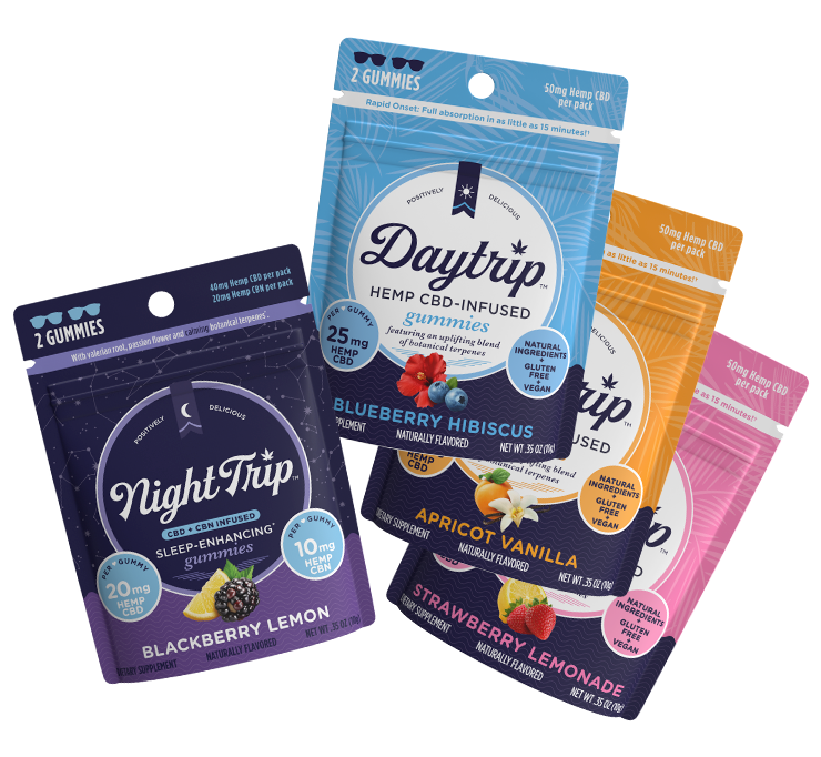 Sample pack showing a stack of 4-pack packaging renders of all four flavors of gummies: Night Trip CBD + CBN-infused blackberry lemon, Daytrip blueberry hibiscus CBD-infused, Daytrip apricot vanilla CBD-infused, and Daytrip strawberry lemonade CBD-infused