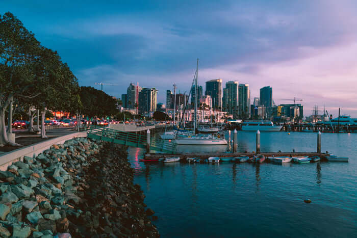 Twilight evening picture of boats moored in san diego harbor with the san diego downtown skyline behind