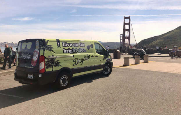 the daytrip team sprinter van parked in marin county with the golden gate bridge in the background