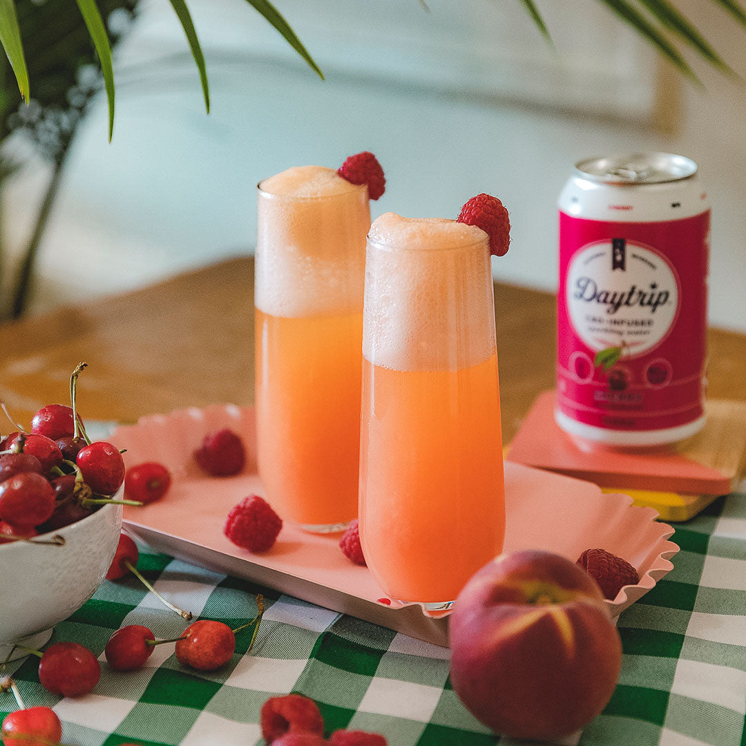 vibrant cocktail photo of the bellini beach featuring Daytrip CBD Infused Sparkling Water