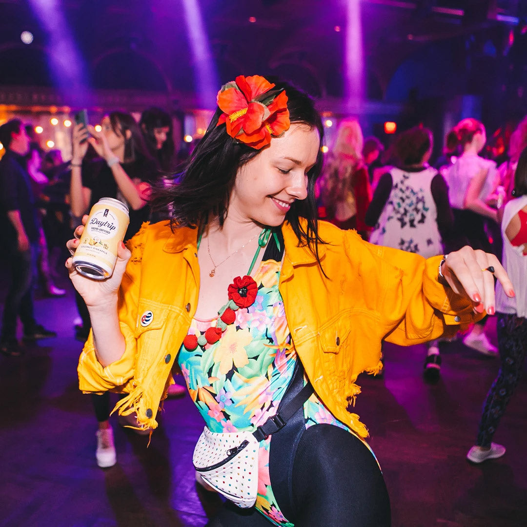 beautiful woman dancing at a night club in brightly colored stylish clothing
