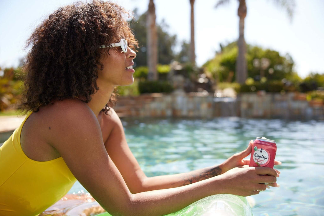 beautiful african american model enjoying a daytrip organic prebiotic soda poolside